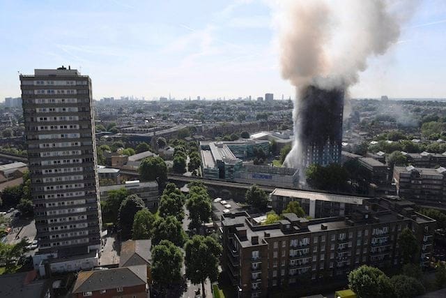 Smoke billows from a fire that has engulfed the 24-storey Grenfell Tower in west London, Wednesday June 14, 2017. Fire swept through a high-rise apartment building in west London early Wednesday, killing an unknown number of people with around 50 people being taken to hospital. (Victoria Jones/PA via AP)
