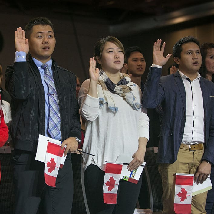 VANCOUVER, CANADA - JULY 1:  Sixty new citizens from 26 countries swear their allegiance to their new nation during a special Canada Day ceremony on July 1, 2016 in Vancouver, British Columbia, Canada.  Vancouver, the largest city in the province, celebrates the country's 149th Canada Day with music, food, a parade, and fireworks in and around Canada Place, the waterfront convention centre. (Photo by George Rose/Getty Images)