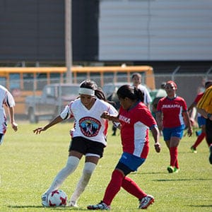 Women's soccer round robin match between Treaty 5 (white jerseys) and Panama (red jerseys) on July 6th at the World Indigenous Nations Games. (Laurie Buffalo)