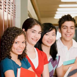 High-school students standing in front of lockers