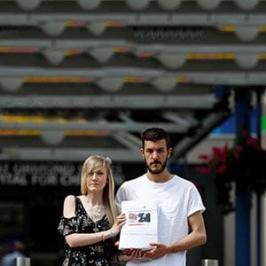 The parents of critically ill baby Charlie Gard, Connie Yates and Chris Gard, pose for the media with a petition, outside Great Ormond Street Hospital, in central London, Britain July 9, 2017. The parents want their son, who has a form of mitochondrial disease, to be able to travel to receive further treatment, after losing a long legal battle to give him experimental therapy in the United States.  (Peter Nicholls/Reuters)