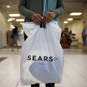 A shopper holds a Sears Canada Inc. bag for a photograph inside a mall in Toronto, Ontario, Canada, on Thursday, June 22, 2017. Canadian retailer Sears Canada Inc. is seeking creditor protection as it works to restructure the business. Sears Canada Inc., the struggling offshoot of Sears Holdings Corp., filed for protection from creditors Thursday after running short on shoppers and cash. (Cole Burston/Bloomberg/Getty Images)
