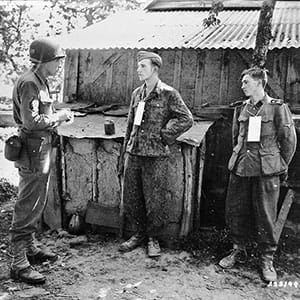 Martin Selling questions German prisoners near the front in France, 1944. (U.S. Army Signal Corps)