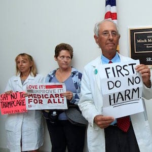 Retired family physician Jay Brock of Fredericksburg, Va., joins other protesters against the Republican health care bill outside the office of Senate Majority Leader Mitch McConnell of Ky., Monday, July 17, 2017, on Capitol Hill in Washington. (AP Photo/Manuel Balce Ceneta)