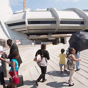 A group of asylum seekers leave Olympic Stadium to go for a walk, in Montreal on Wednesday, August 2, 2017. The stadium is being used as temporary housing to deal with the influx of asylum seekers arriving from the United States. (Ryan Remiorz/CP)