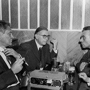 Writers Joseph KESSEL Jean-Paul SARTRE and, to the latter's right, the reporter Roger PRIOURET conversing at the close of reporter Georges ARNAUD's trial. ARNAUD was sentenced to a two year suspended prison sentence. The scene takes place in a Paris cafe near the military tribunal of Paris, on June 18, 1960.  (Keystone-France/Gamma-Keystone/Getty Images)