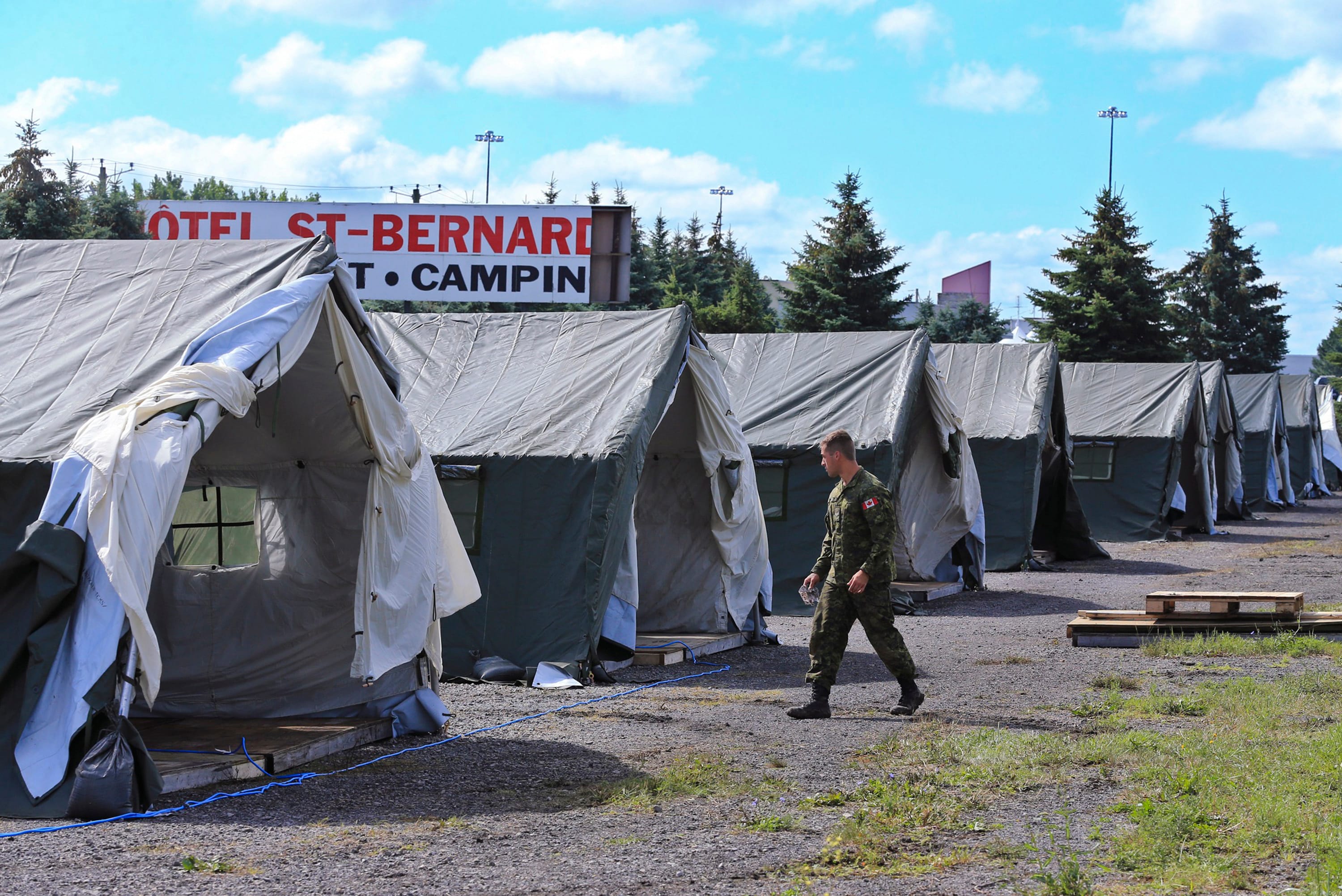 The migrant camp is expanded by the military located on the Canadian border on Saturday, Aug. 12, 2017. Thousands of people have crossed over into Canada from an irregular crossing near the Champlain-St. Bernard de Lacolle border in hopes of finding residency in Canada. Among them are Haitians who worry that their Temporary Protected Status in the U.S. could soon end under the Trump administration. (Al Diaz/Miami Herald/TNS via Getty Images)