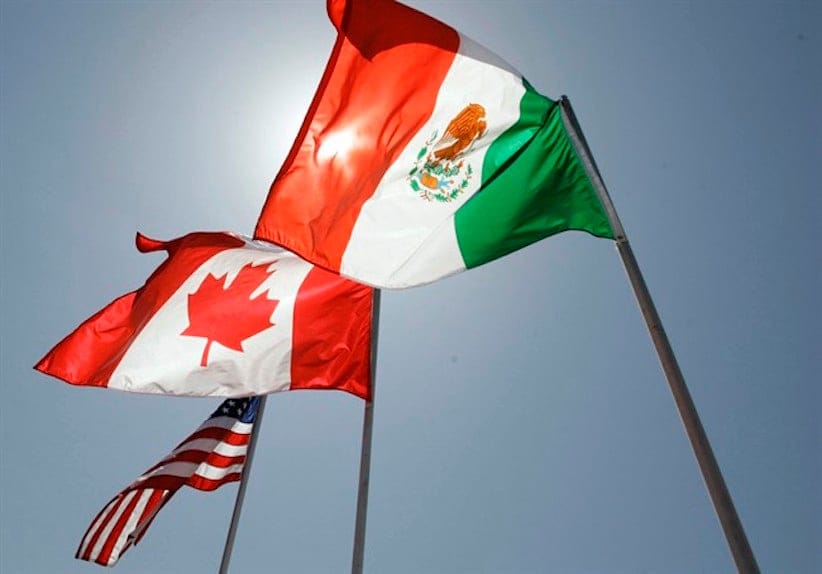 In this April 21, 2008 file photo, national flags of the United States, Canada, and Mexico fly in the breeze in New Orleans. Negotiations start Wednesday for an update to the quarter-century-old North American Free Trade Agreement. THE CANADIAN PRESS/AP/Judi Bottoni