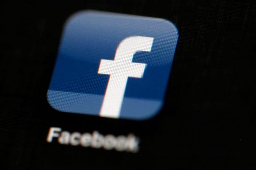 FILE - In this May 16, 2012 file photo, the Facebook logo is displayed on an iPad in Philadelphia.  Facebook is adding more Snapchat-like features to its app. The company says it wants to let people's cameras "do the talking" as more people are posting photos and videos instead of blocks of text. With the update coming to users starting Tuesday, March 28, 2017,  Facebook is adding a camera icon to the top left corner of its mobile app.. (Matt Rourke/AP)