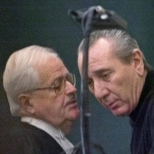 Vito Rizzuto (right) reputed head of the Montreal Mafia, speaks with his attorney Jean Salois after his hearing in Montreal Friday, Feb. 6, 2004. Rizzuto faces extradition to the United States to face charges related to the murders of three Mafia captains in New York in 1981. (CP PHOTO/Ryan Remiorz)