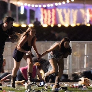 LAS VEGAS, NV - OCTOBER 01:  People run from the Route 91 Harvest country music festival after apparent gun fire was hear on October 1, 2017 in Las Vegas, Nevada. A gunman has opened fire on a music festival in Las Vegas, leaving at least 20 people dead and more than 100 injured. Police have confirmed that one suspect has been shot. The investigation is ongoing. (Photo by David Becker/Getty Images)