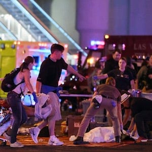 LAS VEGAS, NV - OCTOBER 02:  An injured person is tended to in the intersection of Tropicana Ave. and Las Vegas Boulevard after a mass shooting at a country music festival nearby on October 2, 2017 in Las Vegas, Nevada. A gunman has opened fire on a music festival in Las Vegas, killing over 20 people. Police have confirmed that one suspect has been shot dead. The investigation is ongoing. (Photo by Ethan Miller/Getty Images)