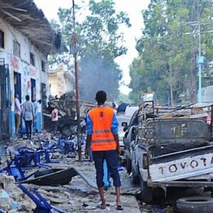 People stand among damages at the scene of a blast after two car bombs exploded in Mogadishu on October 28, 2017.
A car packed with explosives blew up outside a hotel in Mogadishu on October 28 as a minibus also exploded at a nearby junction, with the emergency services reporting "many dead bodies". Witnesses reported hearing gunfire and said the entire area around the Nasa Hablod hotel was sealed off by security forces to keep people away. The blasts occurred just two weeks after a huge truck bombing in the Somali capital which killed at least 358 people, making it the deadliest attack in the country's history. 
 / AFP PHOTO / Mohamed ABDIWAHAB        (Photo credit should read MOHAMED ABDIWAHAB/AFP/Getty Images)