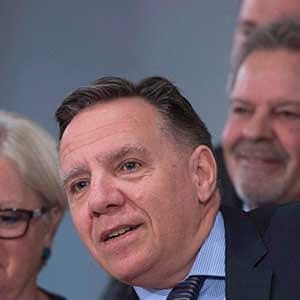 Coalition Avenir Quebec Leader Francois Legault, centre, is applauded at a news conference marking the end of the spring session, Friday, June 16, 2017 at the legislature in Quebec City. Legault is accompanied by members of his caucus. THE CANADIAN PRESS/Jacques Boissinot