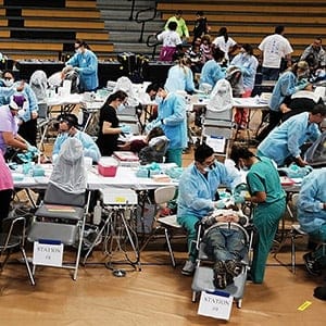 People wait to see a dentist at the Remote Area Medical (RAM) mobile dental and medical clinic on December 3, 2016 in Milton, Florida. It is expected that over a thousand people will show up seeking free dental and medical care at the two-day event in the financially struggling Florida panhandle community. RAM provides free medical care through mobile clinics in underserved, isolated, or impoverished communities around the country and world. As health-care continues to be a contentious issue in America, an estimated  29 million Americans, about one in 10, lack coverage.  (Spencer Platt/Getty Images)