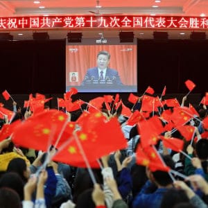 College students wave national flags as they watch the opening of the 19th Communist Party Congress in Huaibei in China's eastern Anhui province on October 18, 2017. 
President Xi Jinping declared China is entering a "new era" of challenges and opportunities on October 18, as he opened a Communist Party congress expected to enhance his already formidable power. (AFP/Getty Images)