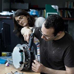 Computing Science Program, Adjunct Professor Adam White uses glue on the Critter Bot as MSC student Banafsheh Rafiee watches, at the University of Alberta in Edmonton Alberta, October 11, 2017. (Photograph by Jason Franson)