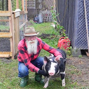 Brent Johnson and his pet Berkshire pig, Pork Chop, which he bought to protest North Bay’s bylaw banning backyard chickens. (Brent Johnson)