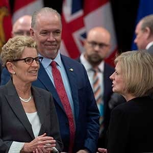 Ontario Premier Kathleen Wynne, and B.C. Premier John Horgan speak with Alberta Premier Rachel Notley beforethe First Ministers Meeting in Ottawa, Tuesday, October 3, 2017. THE CANADIAN PRESS/Adrian Wyld
