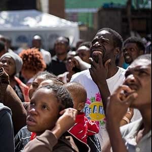 Haitian migrants seeking asylum in the United States, listen to announcements as they wait for their opportunity to get a spot at the Padre Chava soup kitchen and shelter in the Mexican border city of Tijuana, in Baja California, on October 6, 2016.
The National Human Rights Commission of Mexico (CNDH) on Saturday called on the government to support the saturated shelters and humanitarian centres for migrants in the border cities of Tijuana and Mexicali, where an increase in the arrival of Haitians and Africans hoping to be allowed to continue north to the United States has been registered. / AFP / Guillermo Arias        (Photo credit should read GUILLERMO ARIAS/AFP/Getty Images)