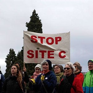Treaty 8 Indigenous First Nations, Human Rights and Environmental Groups gather with supporters to deliver petitions, postcards and messages of solidarity inside a canoe following the government's reports on the controversial Site C dam study during a protest on Lekwungen Territory at Legislature in Victoria, B.C., on Thursday, November 2, 2017. (Chad Hipolito/CP)
