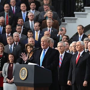 WASHINGTON, DC - DECEMBER 20:  U.S. President Donald Trump, flanked by Republican lawmakers, celebrates Congress passing the Tax Cuts and Jobs Act on the South Lawn of the White House on December 20, 2017 in Washington, DC. The tax bill is the first major legislative victory for the GOP-controlled Congress and Trump since he took office almost one year ago.  (Photo by Chip Somodevilla/Getty Images)
