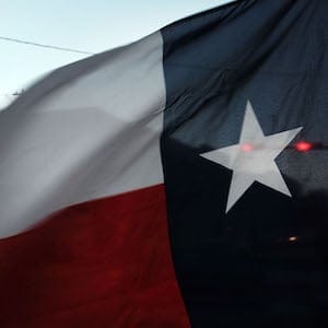 SWEETWATER, TX - JANUARY 19:  The Texas flag flies in downtown Sweetwater on January 19, 2016 in Sweetwater, Texas. Global oil prices continue their downward fall with U.S. oil dropping towards $27 a barrel, its lowest since 2003, on worries about global oversupply. Following a diplomatic agreement on nuclear fuel with America, Iran has forecast it will add 500,000 barrels per day to global production, following the lifting of sanctions.  (Photo by Spencer Platt/Getty Images)