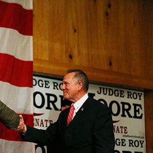 Steve Bannon, left, introduces U.S. senatorial candidate Roy Moore, right, during a campaign rally, Tuesday, Dec. 5, 2017, in Fairhope, Ala. (AP Photo/Brynn Anderson)