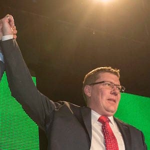 Outgoing Saskatchewan Premier Brad Wall, left, lifts the arm of Scott Moe who won the party leadership and becomes the new Saskatchewan Premier during the Saskatchewan Party Leadership Convention in Saskatoon, Saturday, January 27, 2018. THE CANADIAN PRESS/Liam Richards