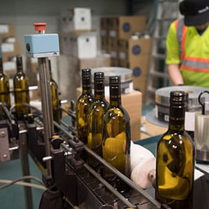 Bottles of wine are packaged at Grey Monk Winery in Kelowna, B.C., Wednesday, May 3, 2017. (Jonathan Hayward/CP)
