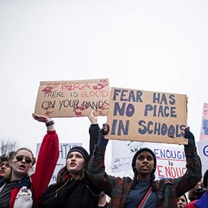 WASHINGTON, DC - FEBRUARY 19: Demonstrators hold signs during a "lie-in" demonstration supporting gun control reform near the White House on February 19, 2018 in Washington, DC. According to a statement from the White House, "the President is supportive of efforts to improve the Federal background check system.", in the wake of last weeks shooting at a high school in Parkland, Florida. (Photo by Zach Gibson/Getty Images)