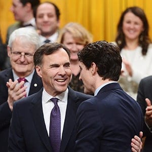 Finance Minister Bill Morneau is congratulated by Prime Minister Justin Trudeau after delivering the federal budget in the House of Commons in Ottawa on Tuesday, Feb.27, 2018. THE CANADIAN PRESS/Sean Kilpatrick
