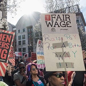 Demonstrators at the U.S. Labor Department headquarters building. Part of nationwide protests coinciding with International Women's Day and the Day Without a Woman.  During the late afternoon rally that followed, speakers demanded an end to workplace violence and harassment, pay equity, one fair living wage, paid leave, and labor rights at the workplace. (Bob Korn/Alamy)