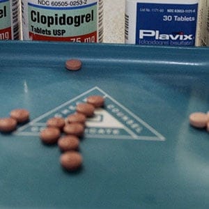Miami, UNITED STATES:  The blood thinners Clopidogrel (L) manafactured by Apotex Inc. and Plavix which are used to prevent heart attacks and strokes are pictured in a pharmacy 10 January 2007 in Miami. Apotex is challenging the validity of a patent covering the main compound in Plavix and is seeking permission to market their generic version of the blood thinner in US federal court in a trial set for 22 January 2007. Manufactured by Paris-based Sanofi and licensed by New York-based Bristol Myers, Plavix generated 6.3 billion USD in global sales last year and is the biggest-selling drug for Bristol-Myers and the second-biggest product for Sanofi.     AFP PHOTO/Robert SULLIVAN  (Photo credit should read ROBERT SULLIVAN/AFP/Getty Images)