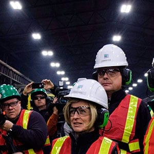 Alberta Premier Rachel Notley, centre, speaks to steel workers as she tours a company producing pipe, casing and tubing for the Canadian oil and gas sector in Calgary, Alta., Friday, Feb. 9, 2018.THE CANADIAN PRESS/Jeff McIntosh