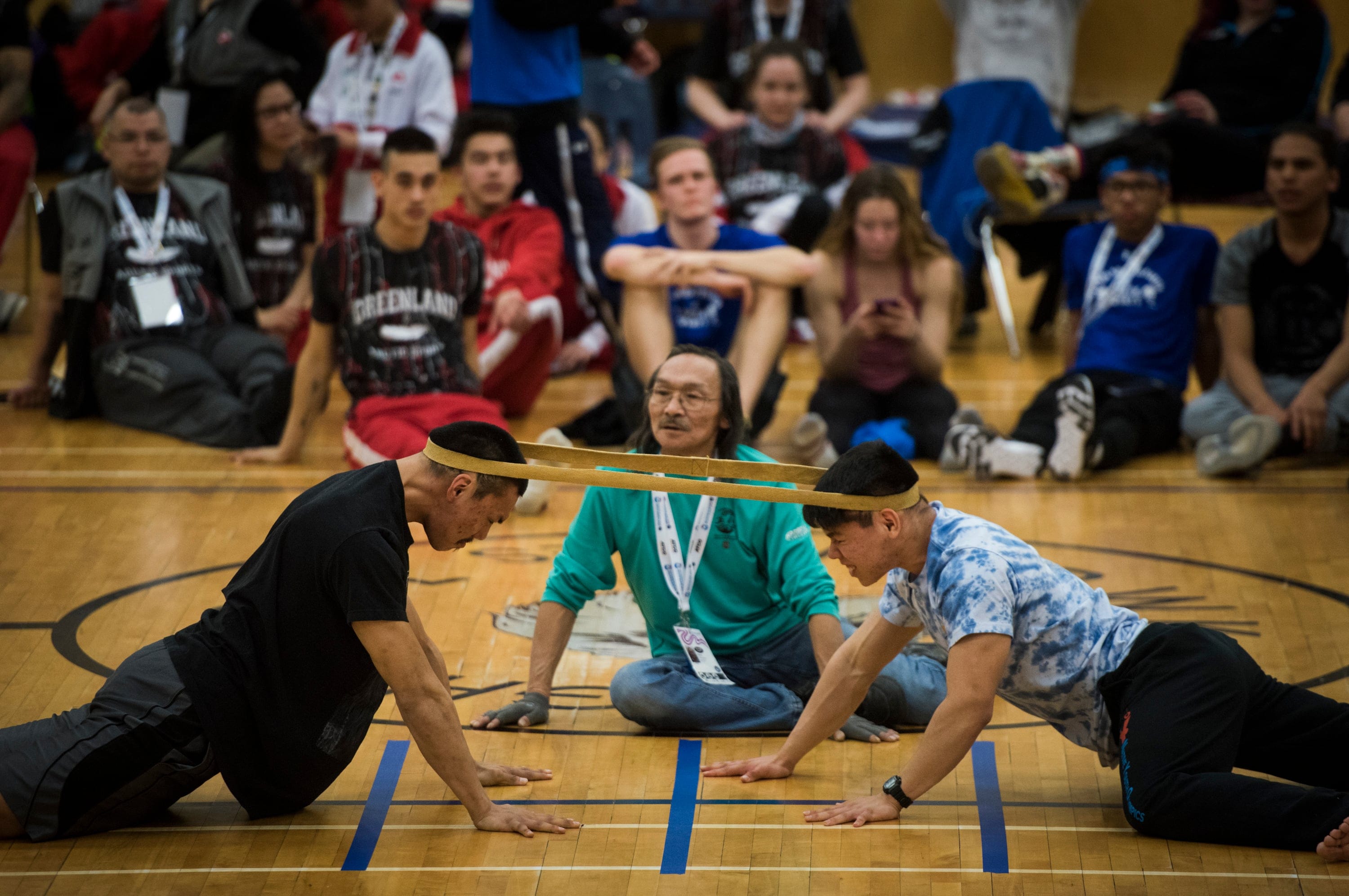 In the Head Pull event, athletes try to pull a moosehide strap off their opponent, a test of their shoulder and neck strength. (Photograph by Pat Kane)