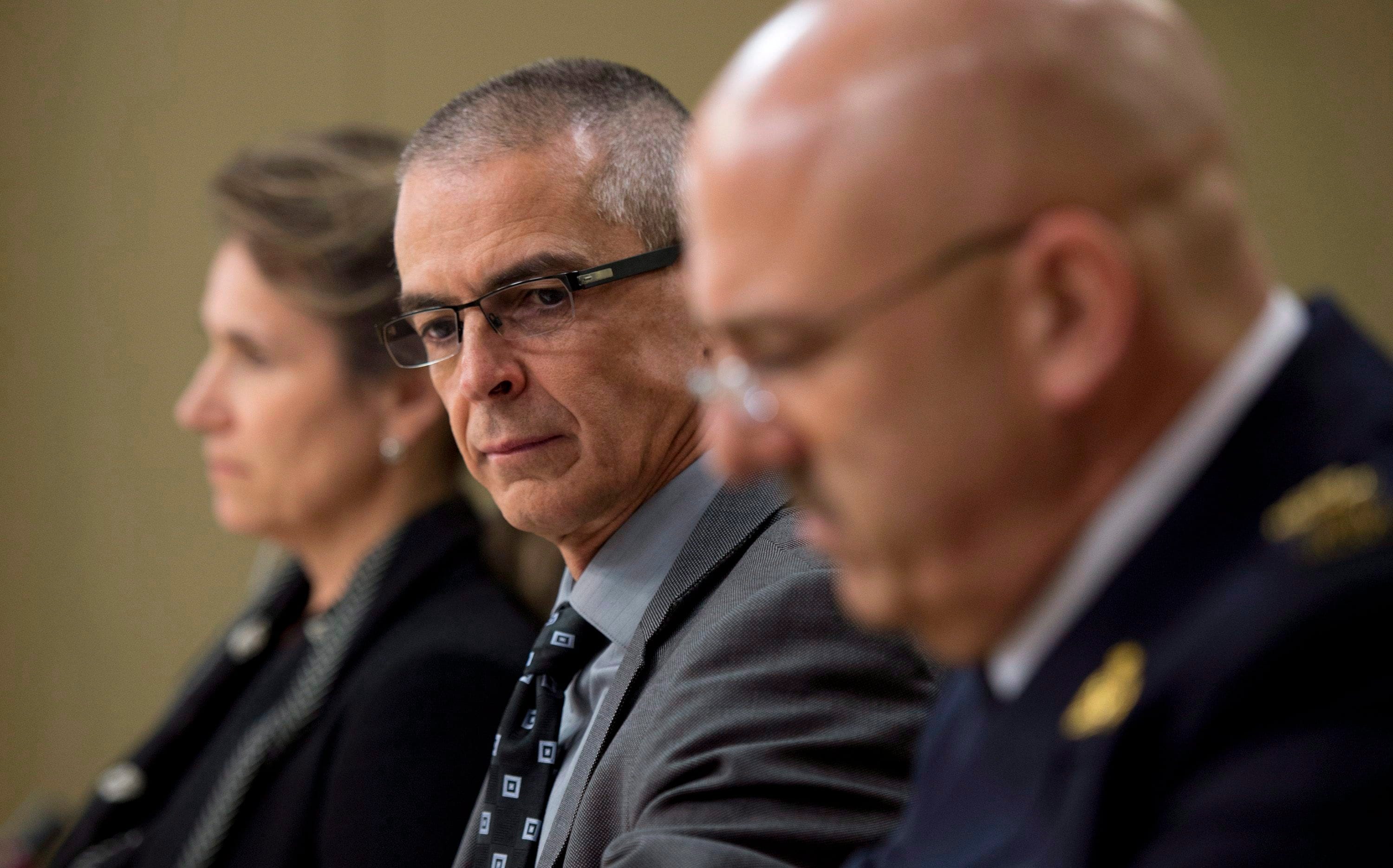 CSIS director Michel Coulombe (centre) waits with RCMP deputy commissioner Mike Cabana (right) and Greta Bossenmaier, Communications Security Establishment chief, to appear at the Senate national security committee to discuss the anti-terrorism act, Bill C-51 in Ottawa, Monday, April 20, 2015. (THE CANADIAN PRESS/Adrian Wyld)