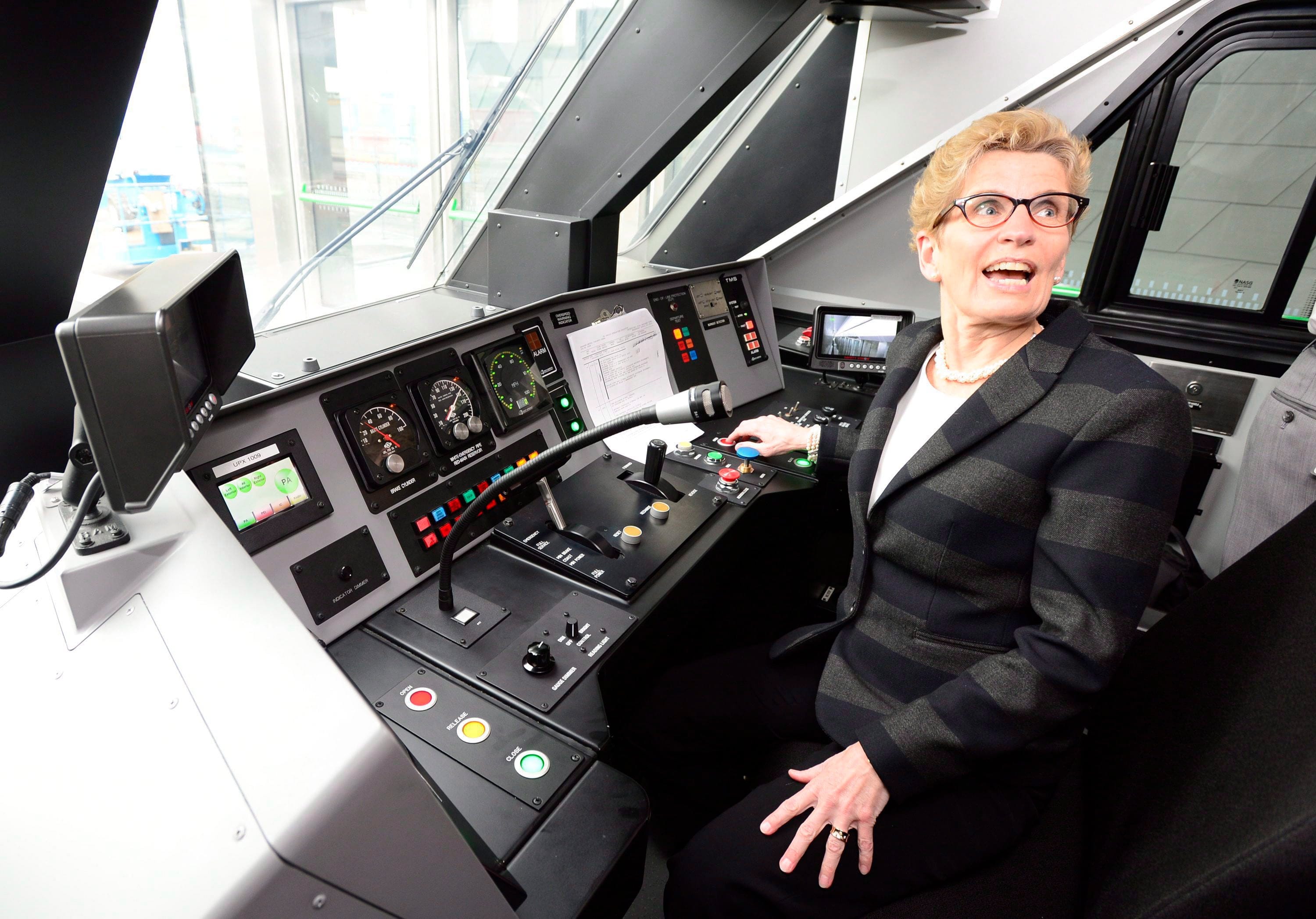 Ontario Premier Kathleen Wynne takes the controls of the Union Pearson Express train from Union Station to Pearson airport in Toronto on Wednesday, April 22, 2015. (THE CANADIAN PRESS/Frank Gunn)