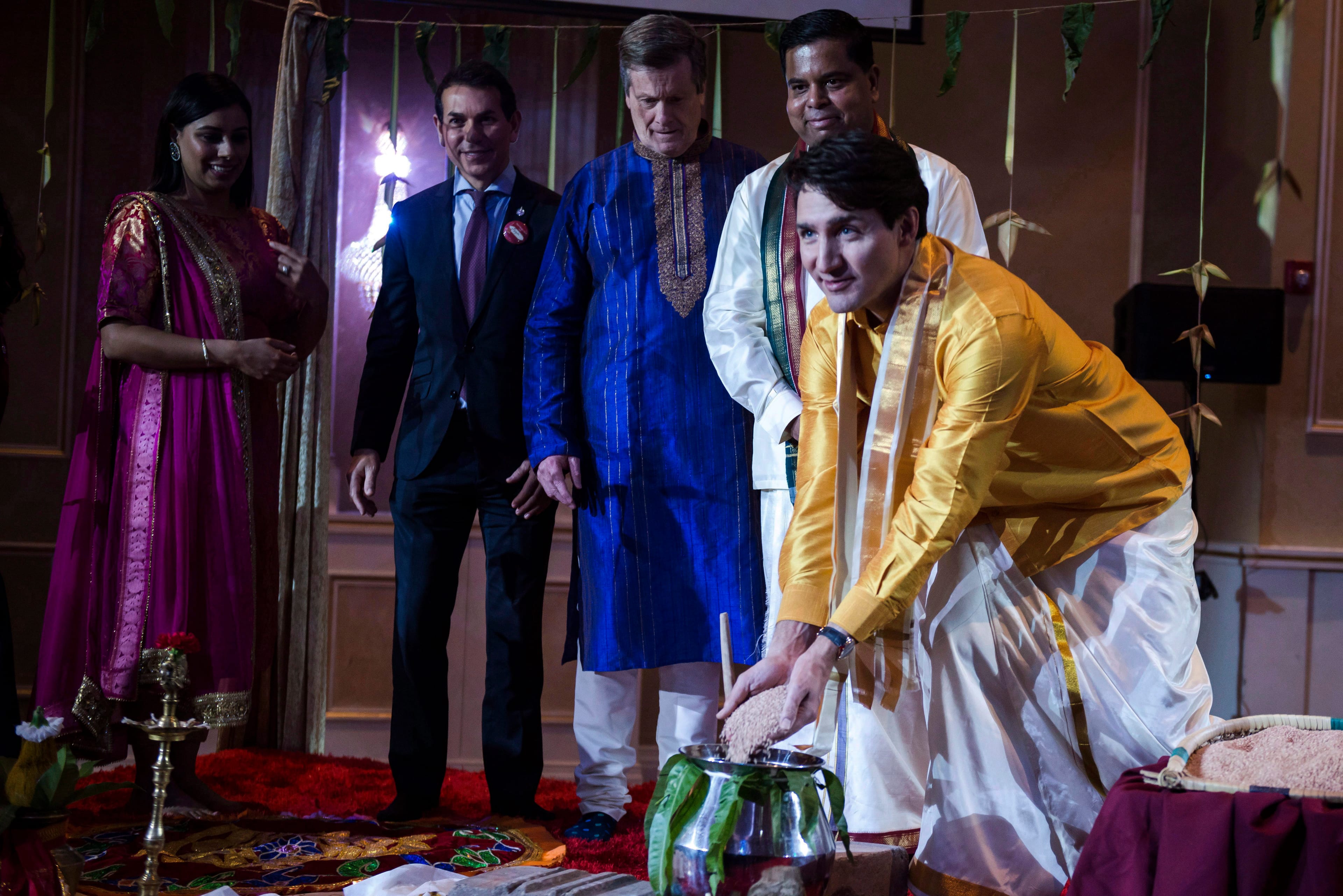 Prime Minister Justin Trudeau and other dignitaries take part in a rice ceremony, marking the start of the Tamil festival, Thai Pongal, in Toronto on Tuesday, Jan. 16, 2018. (THE CANADIAN PRESS/Christopher Katsarov)