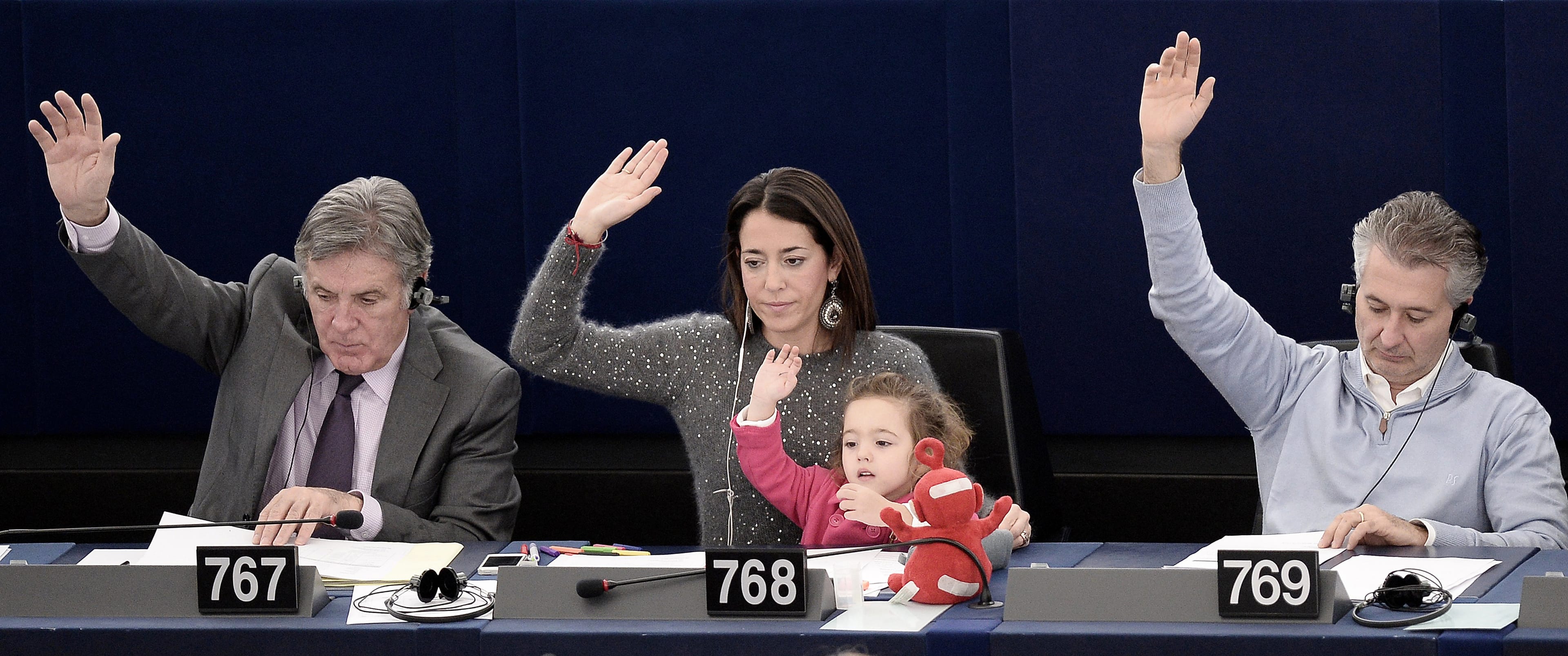 Italy's Member of the European Parliament Licia Ronzulli (C) takes part with her daughter Victoria in a vote during a plenary session of the European parliament in Strasbourg, eastern France. (Frederick Florin/AFP/Getty Images)
