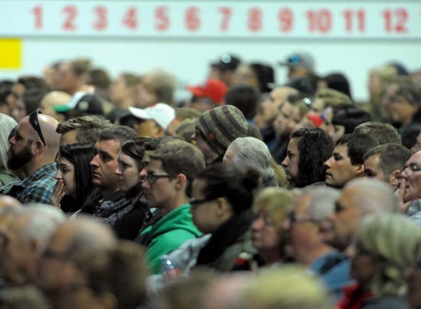 An overflow crowd sits in the curling rink beside the Elgar Petersen Arena in Humboldt, Sask., during a vigil Sunday night to honour the 15 killed Friday night when the Humboldt Broncos bus collided with a semi-trailer outside of Nipawin, Sask. (Photograph by Mark Taylor)