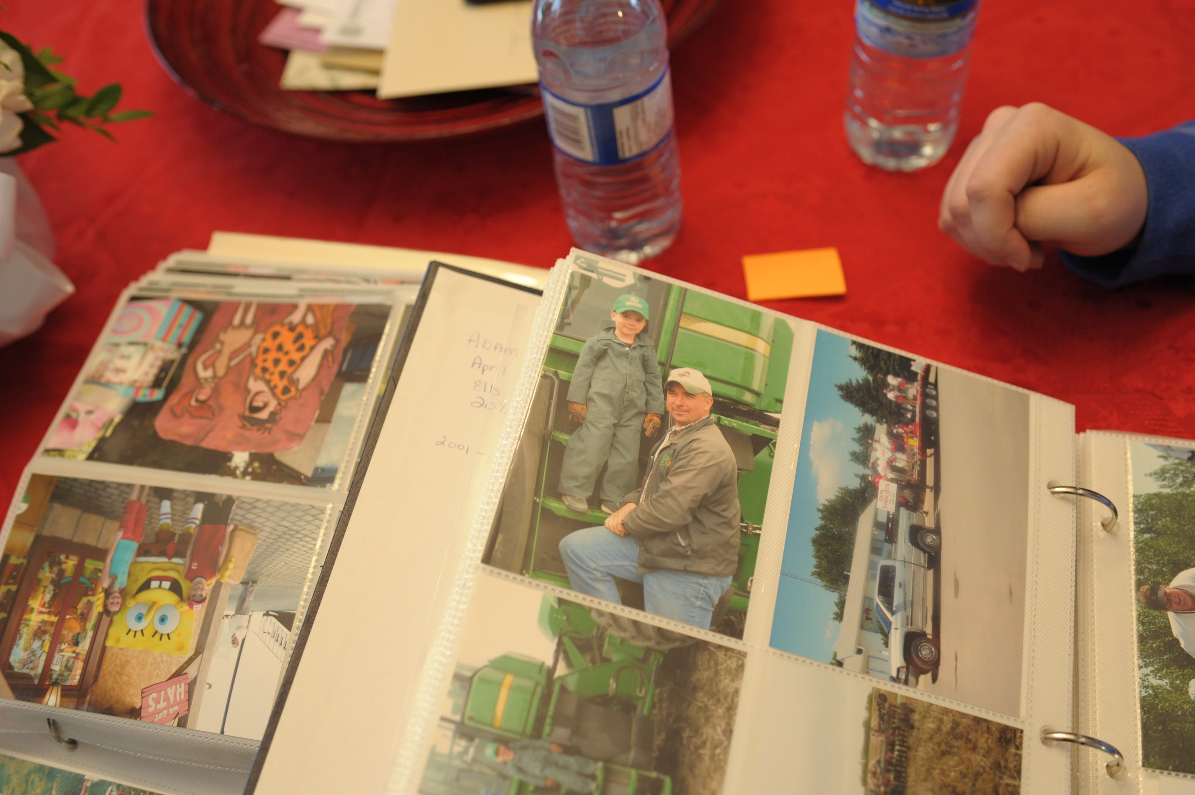 Russell Herold goes through family photo albums at his Montmartre farm while reminiscing about his son, Adam, a recent Humboldt Bronco call-up killed when the team bus collided with a semi-trailer outside Nipawin, Sask. Photograph by Mark Taylor