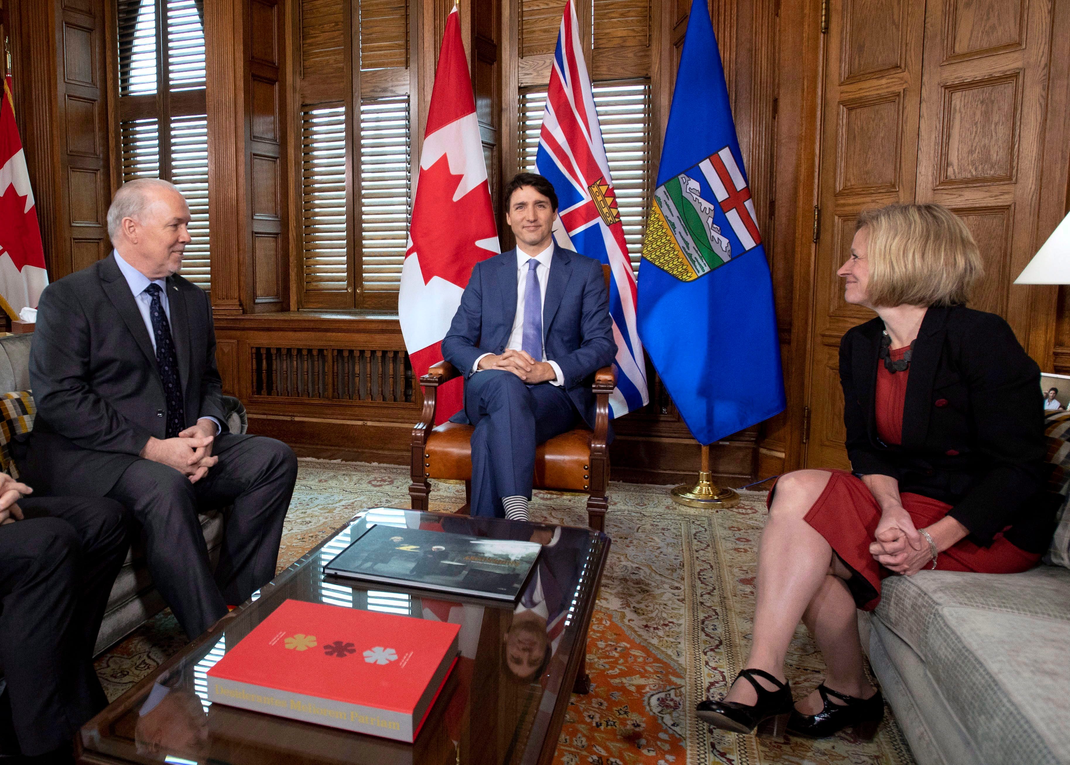 Prime Minister Justin Trudeau, B.C. Premier John Horgan, left, and Alberta Premier Rachel Notley, sit in Trudeau's office on Parliament Hill for a meeting on the deadlock over Kinder Morgan's Trans Mountain pipeline expansion, in Ottawa on Sunday, April 15, 2018. THE CANADIAN PRESS/Justin Tang