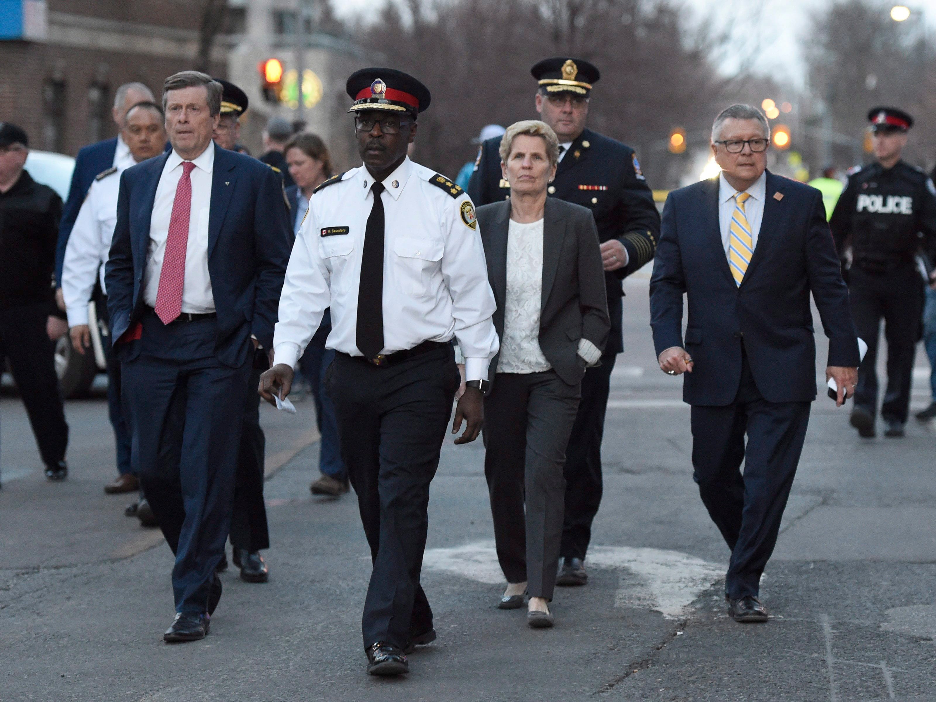 Toronto Mayor John Tory, left to right, Toronto Police Chief Mark Saunders, Premier Wynne and Ralph Goodale, Federal Minister of Public Safety and Emergency Preparedness, walk together towards a news conference after viewing the scene where nine people died and 16 others were injured when a van mounted a sidewalk and struck multiple pedestrians Toronto on Monday, April 23, 2018. THE CANADIAN PRESS/Nathan Denette