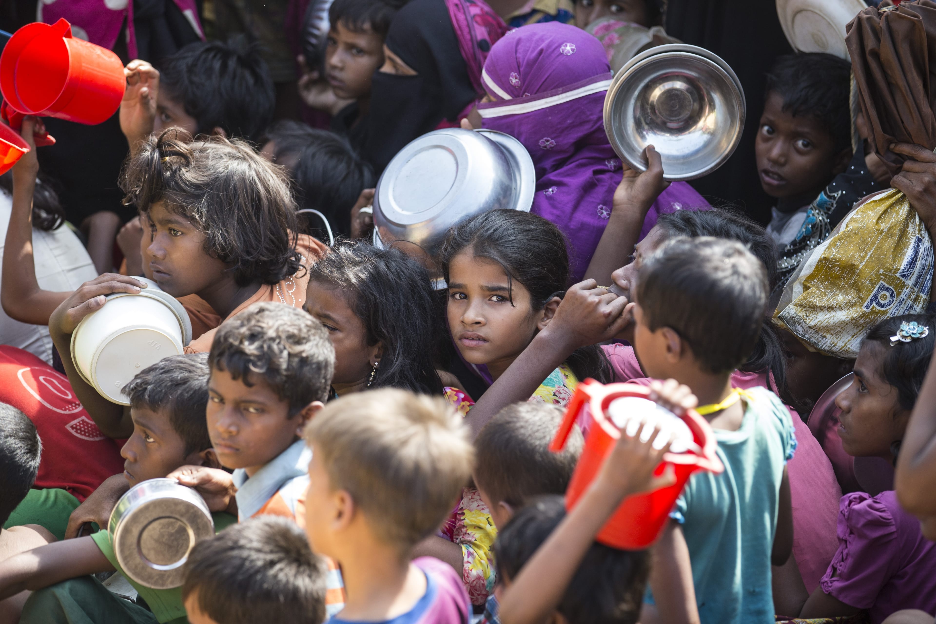 Rohingya people wait in line to receive food aid at Kutupalong refugee camp in Maynar Guna, near Cox's Bazar, Bangladesh on Dec. 19, 2017. (Mustafa Kamaci/Anadolu Agency/Getty Images)