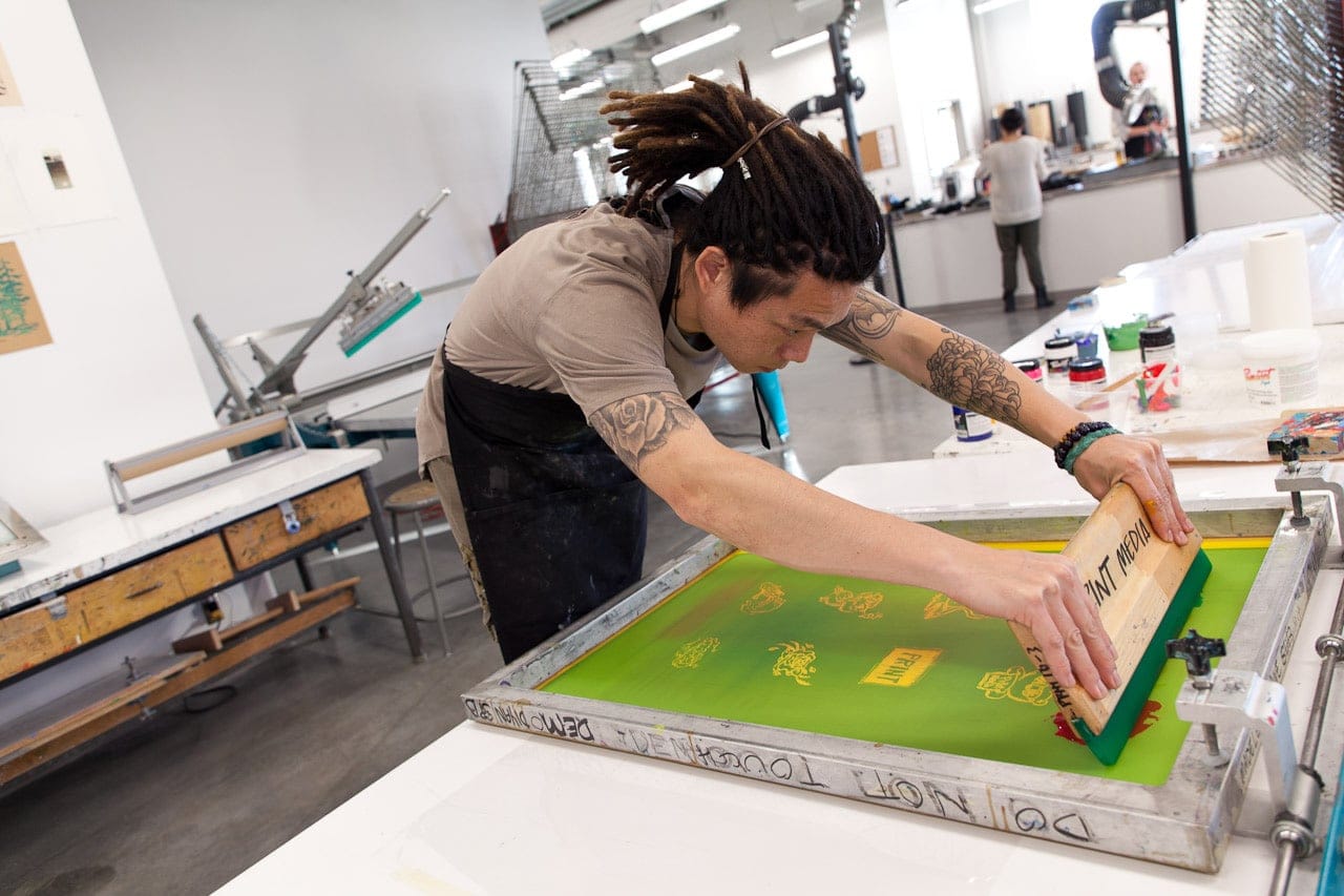 A student silk screening at Emily Carr University of Art + Design. (ECUAD)