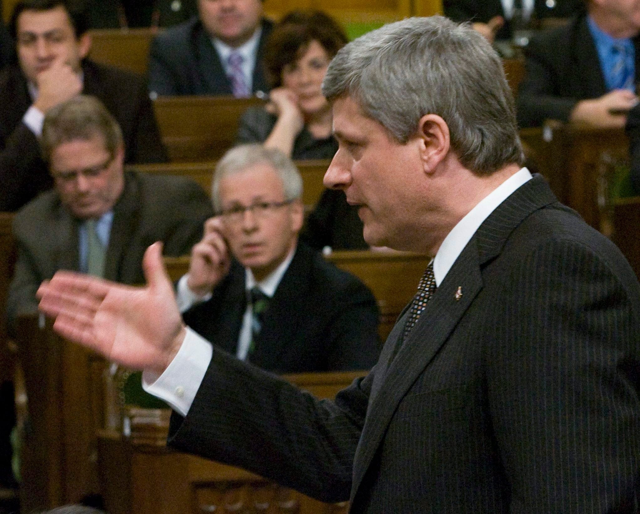 Prime Minister Stephen Harper responds to a question from Liberal leader Stephane Dion, back, during Question Period in the House of Commons on Parliament in Ottawa Tuesday Dec. 2, 2008. THE CANADIAN PRESS/Tom Hanson