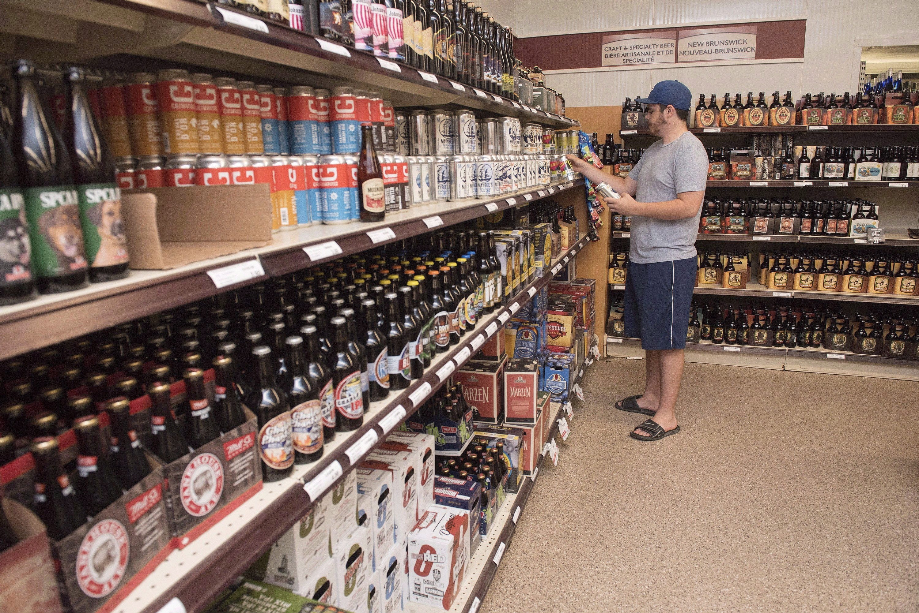 Customer Matt Oliver shops in the craft beer section of the NB Liquor store attached to the old Fredericton Railway Station in Fredericton, N.B., on Friday, June 16, 2017. A Supreme Court of Canada ruling that provinces have the right, with limits, to enact laws that restrict interprovincial commerce represents a "missed opportunity" to free up trade within Canada, industry observers say.THE CANADIAN PRESS/Stephen MacGillivray