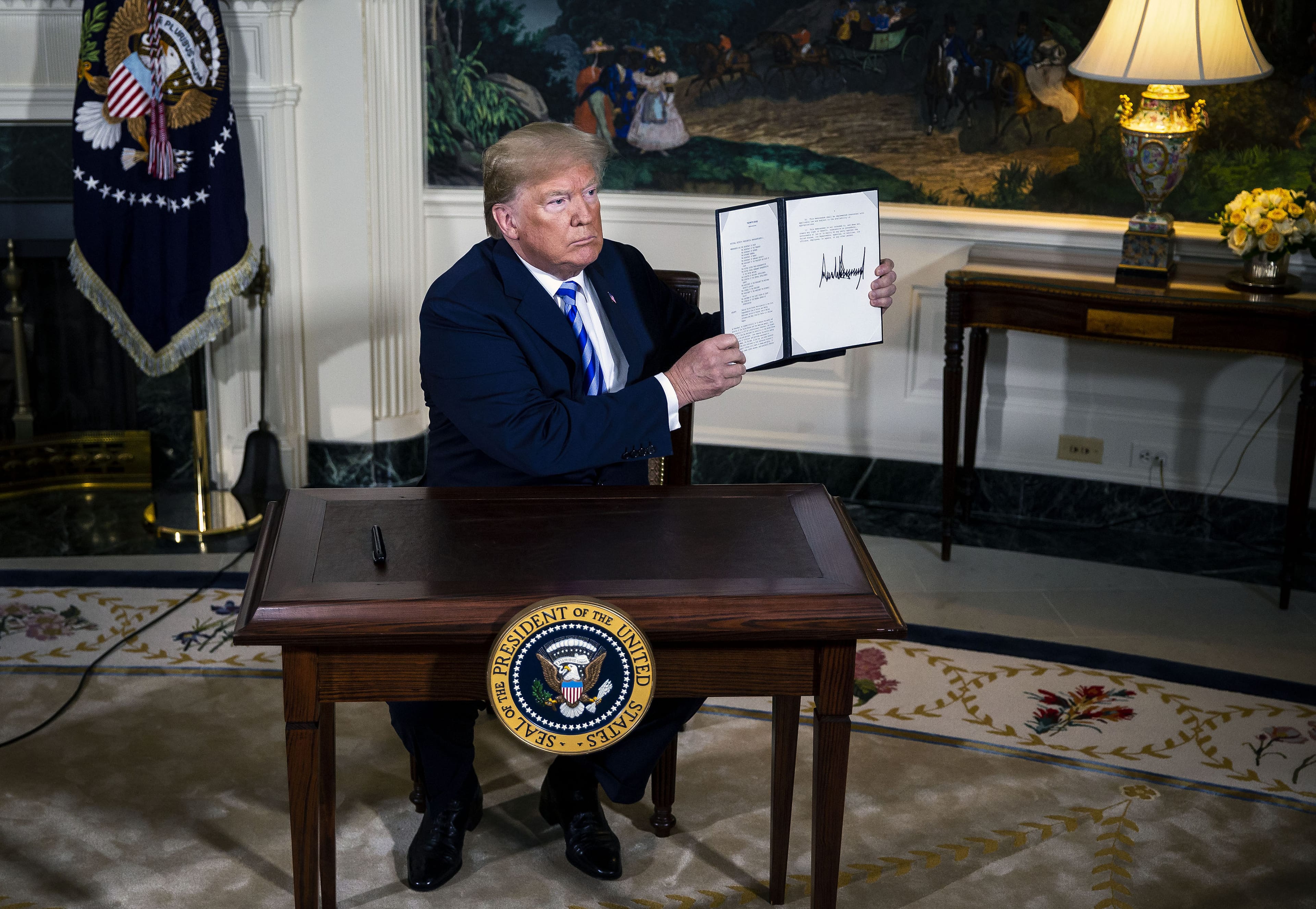 U.S. President Donald Trump displays a signed Presidential Memorandum  on Tuesday, May 8, 2018, after stating the U.S. will withdraw from the landmark 2015 accord to curb Iran's nuclear program (Al Drago/Bloomberg via Getty Images)