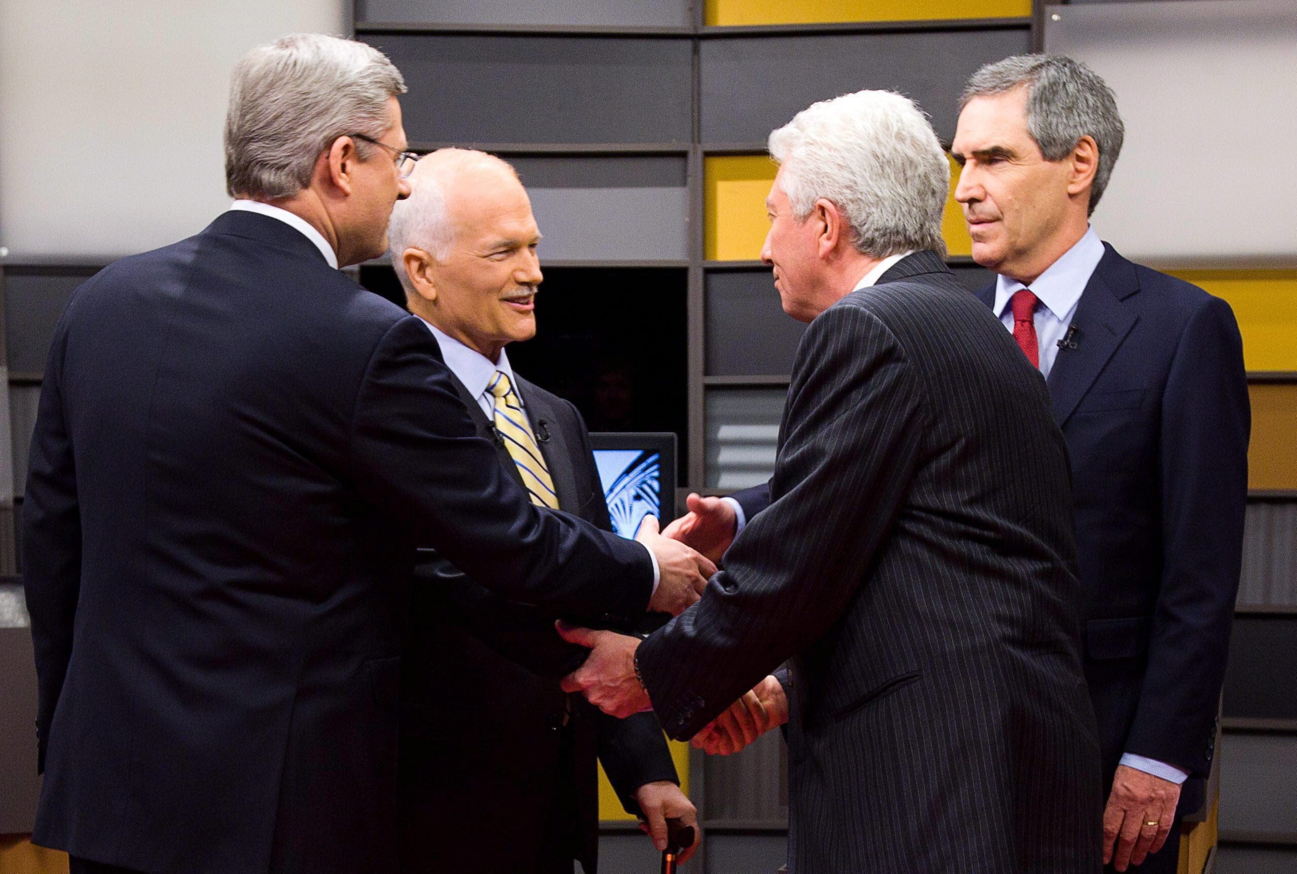 Prime Minister Stephen Harper, left to right, New Democratic Party leader Jack Layton,  Bloc Quebecois leader Gilles Duceppe and Liberal leader Michael Ignatieff, exchange hand shakes as they arrive to the English language federal election debate in Ottawa Ont., on Tuesday, April 12, 2011.  THE CANADIAN PRESS/Adrian Wyld